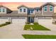 Charming townhome featuring a well-manicured lawn and paved driveway leading to an attached two-car garage at 3644 Pitch Ln, Sarasota, FL 34232