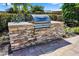 Outdoor grilling area with a built-in stone grill perfect for entertaining at 3644 Pitch Ln, Sarasota, FL 34232