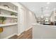 A charming kitchen with hardwood floors, a well-lit nook with shelves, and views into an airy room at 3644 Pitch Ln, Sarasota, FL 34232