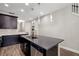 Sleek kitchen featuring a central island with a sink, stainless steel dishwasher, and custom cabinetry at 3644 Pitch Ln, Sarasota, FL 34232