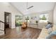 Bright living room with vaulted ceilings, wood-look flooring, and sliding glass doors to screened lanai at 3644 Pitch Ln, Sarasota, FL 34232