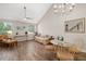 Cozy living room with hardwood floors, large windows, vaulted ceilings, and elegant chandelier and staircase view at 3644 Pitch Ln, Sarasota, FL 34232