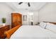 Spacious bedroom with trey ceiling, fan, wood-look floors, and a glimpse of the ensuite bathroom at 3644 Pitch Ln, Sarasota, FL 34232