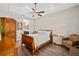 Charming bedroom features trey ceiling with fan, ensuite bathroom, and classic wood furnishings at 3644 Pitch Ln, Sarasota, FL 34232