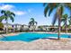Community pool surrounded by palm trees and lounge chairs providing a serene outdoor space at 3644 Pitch Ln, Sarasota, FL 34232