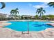 Inviting community pool surrounded by palm trees and comfortable lounge areas at 3644 Pitch Ln, Sarasota, FL 34232