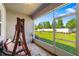 Screened in porch with brick floor, porch swing, and backyard view at 3644 Pitch Ln, Sarasota, FL 34232