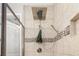 Modern shower with a rainfall showerhead, handheld sprayer, and decorative tile accents at 3644 Pitch Ln, Sarasota, FL 34232