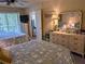 Bedroom features two beds with star-patterned comforters, a dresser, and sliding glass doors to the outside at 3660 Lake Bayshore Dr # K-321, Bradenton, FL 34205