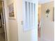 Hallway with a decorative beach-themed painting and wall sconce with a palm tree detail at 3660 Lake Bayshore Dr # K-321, Bradenton, FL 34205
