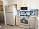 Well-lit kitchen showcases modern appliances and ample counter space for cooking at 3660 Lake Bayshore Dr # K-321, Bradenton, FL 34205
