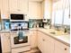 Bright kitchen features white appliances and ample counter space for preparing meals at 3660 Lake Bayshore Dr # K-321, Bradenton, FL 34205