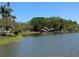 Picturesque lake view featuring surrounding greenery and mature shade trees at 3660 Lake Bayshore Dr # K-321, Bradenton, FL 34205