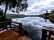 Stunning waterfront view from private dock with reflections of the clouds and buildings in the tranquil water at 3660 Lake Bayshore Dr # K-321, Bradenton, FL 34205