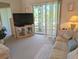 Cozy living room offers a comfortable seating area and access to the balcony at 3660 Lake Bayshore Dr # K-321, Bradenton, FL 34205