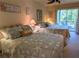 Cozy main bedroom with twin beds and sliding doors to a private balcony at 3660 Lake Bayshore Dr # K-321, Bradenton, FL 34205