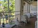 Screened-in porch with comfortable seating, a table, and a view of the lush landscaping at 3660 Lake Bayshore Dr # K-321, Bradenton, FL 34205