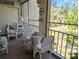 Comfortable screened-in porch with views of the outside, featuring wicker furniture and decor at 3660 Lake Bayshore Dr # K-321, Bradenton, FL 34205