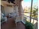 Screened-in porch furnished with white wicker furniture and offering serene views of the surrounding landscape at 3660 Lake Bayshore Dr # K-321, Bradenton, FL 34205
