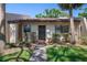 Inviting single-story home with a neatly landscaped front yard, bushes and a walkway leading to the entrance at 3673 Longmeadow # 18, Sarasota, FL 34235