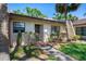Charming single-story home featuring a well-maintained landscape with lush greenery and tropical flowers at 3673 Longmeadow # 18, Sarasota, FL 34235