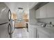 Bright kitchen featuring tile floors, and modern appliances including a washer and dryer at 3673 Longmeadow # 18, Sarasota, FL 34235