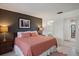 Main bedroom with en-suite bathroom, complemented by an artistic decor and ample closet space at 3673 Longmeadow # 18, Sarasota, FL 34235