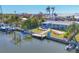 Aerial view of waterfront home showcasing canal access, boat dock, and outdoor patio at 4908 Arlington Rd, Palmetto, FL 34221