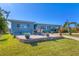 A cozy backyard patio with outdoor seating and waterfront views, perfect for enjoying the outdoors at 4908 Arlington Rd, Palmetto, FL 34221