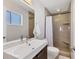 Modern bathroom featuring a sleek vanity, tile shower with a built-in bench, and a window for natural light at 4908 Arlington Rd, Palmetto, FL 34221