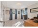 Bright bedroom with terrazzo floors, three windows with blue curtains and a closet with sliding mirror doors at 4908 Arlington Rd, Palmetto, FL 34221