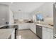 Bright kitchen featuring all-white cabinetry, stainless steel appliances, and marble countertops at 4908 Arlington Rd, Palmetto, FL 34221