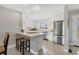 Bright kitchen with stainless steel appliances, white cabinetry, and a convenient breakfast bar at 4908 Arlington Rd, Palmetto, FL 34221