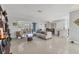 Spacious living area with stylish furnishings and dining area featuring terrazzo flooring at 4908 Arlington Rd, Palmetto, FL 34221