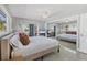 Inviting main bedroom with serene natural light, ceiling fan, and mirrored closet doors at 4908 Arlington Rd, Palmetto, FL 34221