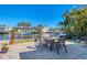 Inviting patio with table and chairs overlooking a canal, offering an ideal space for outdoor dining and relaxation at 4908 Arlington Rd, Palmetto, FL 34221