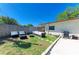 Backyard showcasing the outdoor seating arrangement in a well-maintained green yard, perfect for relaxation at 507 Shore Dr, Largo, FL 33771