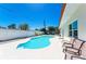 Private backyard with a sparkling pool, patio seating, and privacy fence at 507 Shore Dr, Largo, FL 33771