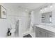 Modern bathroom with a tiled walk-in shower, toilet, and vanity with storage at 507 Shore Dr, Largo, FL 33771