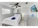 Bedroom featuring a bed, ceiling fan, dresser, TV, and nightstand at 507 Shore Dr, Largo, FL 33771