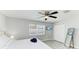 Cozy bedroom with a ceiling fan, window, TV, closet, and a full length mirror at 507 Shore Dr, Largo, FL 33771