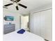 Bedroom featuring a bed, ceiling fan, dresser, mounted TV, and closet at 507 Shore Dr, Largo, FL 33771