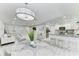 Open-concept living space with dining area, modern lighting, and a view of the kitchen at 507 Shore Dr, Largo, FL 33771