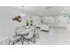 Bright dining area featuring a modern chandelier, stylish table setting, and views of the living room at 507 Shore Dr, Largo, FL 33771