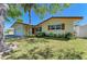 Charming single-story home with a well-kept lawn, beautiful landscaping and mature trees in a peaceful setting at 507 Shore Dr, Largo, FL 33771