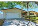 Charming single-story home with a two-car garage, well-kept lawn, and mature trees offering shade at 507 Shore Dr, Largo, FL 33771
