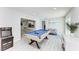 Entertain in this game room featuring a pool table, arcade game, and comfortable seating at 507 Shore Dr, Largo, FL 33771