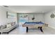 Enjoy this game room with a pool table, comfortable seating, and a view of the pool at 507 Shore Dr, Largo, FL 33771