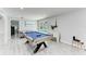 Game room featuring a pool table, desk, and access to the outdoor pool at 507 Shore Dr, Largo, FL 33771