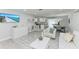 Open-concept living space transitioning to a bright kitchen and dining area at 507 Shore Dr, Largo, FL 33771